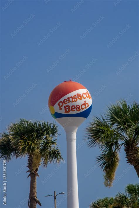 Iconic Pensacola Beach Beachball Water Tower Standing Above Palm Trees