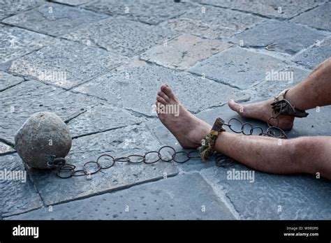 Prisioner With Ball And Chain In The Court Of The Prison Close Up