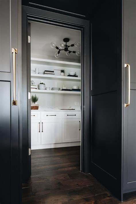 Are your kitchen cupboards a jumbled mess? White kitchen pantry hidden behind a door with flanked by ...
