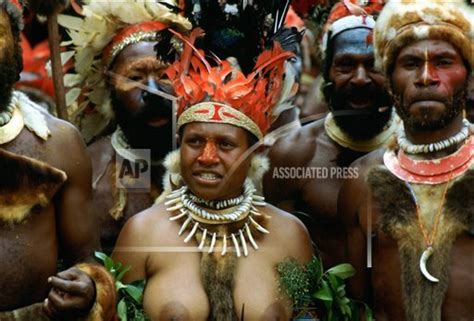 Bare Breasted Tribeswoman And Tribesmen Wearing Face Paints Bone