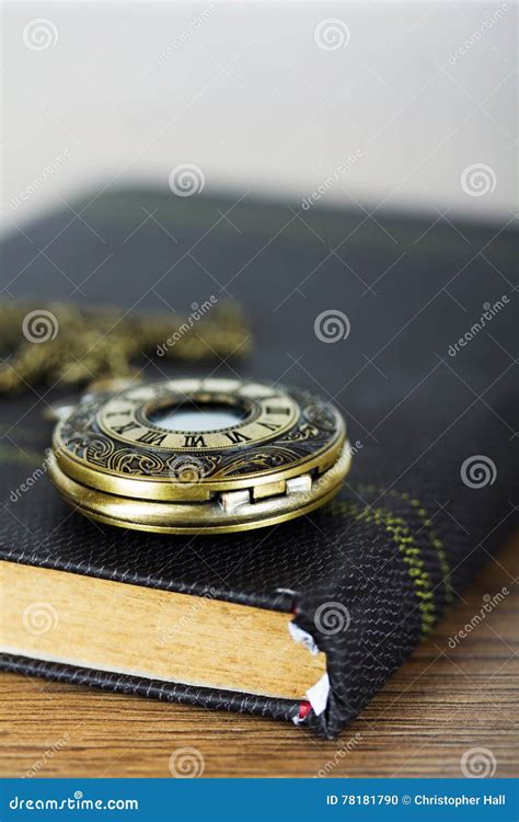 Pocket Watch And Book Against A Rustic Background Stock Photo Image