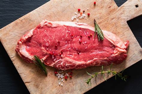 Premium Photo Organic Glass Feed Raw Meat Filet Beef Steak On Black