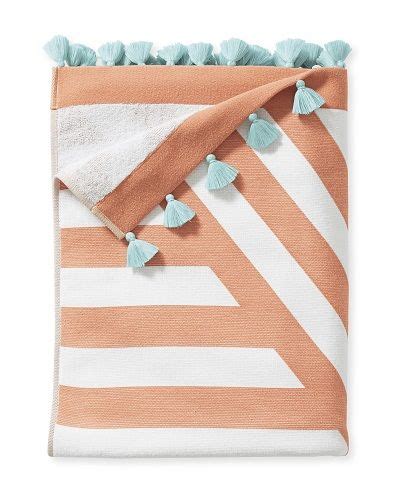 An Orange And White Striped Blanket With Tassels On The Edges Two Blue