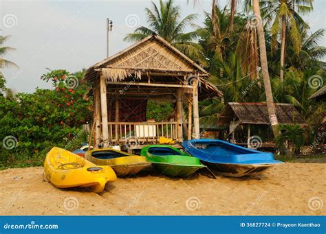 Tropical Beach Setting With Coconut Trees Hut And Bed Stock Photo