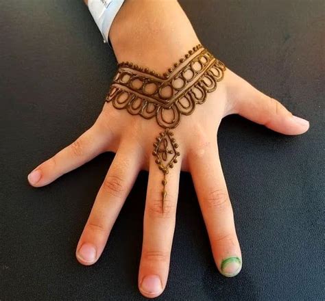 A Woman S Hand With Henna On It