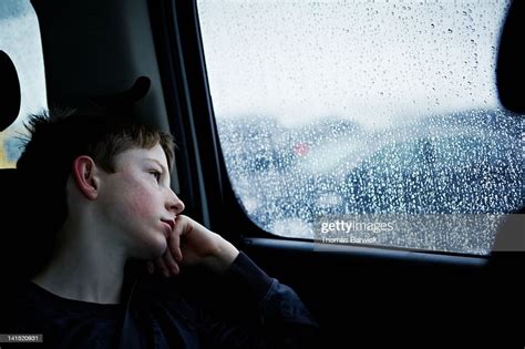 Young Boy Looking Out Rainy Car Window High Res Stock Photo Getty Images
