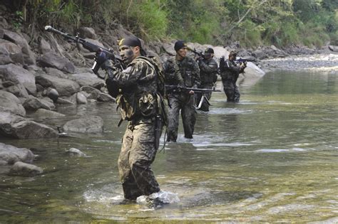 Peruvian Army Commandos Walk Along A Riverbank In The Vrae In Search Of