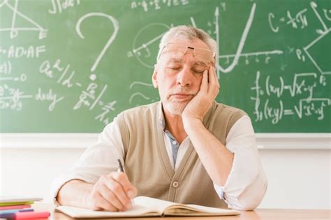 Free Photo Tired Aged Math Teacher Sleeping At Desk