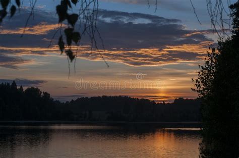 Beautiful Sunset Over A Forest Lake Reflection Of The Setting Sun In