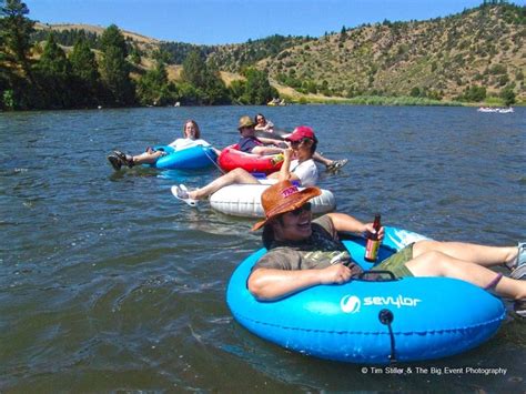 Several People Are Floating On Inflatable Rafts And Having Fun At The Lake