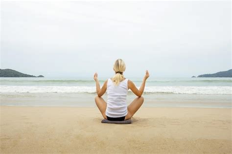 Premium Photo Mature Woman Practicing Yoga On The Beach