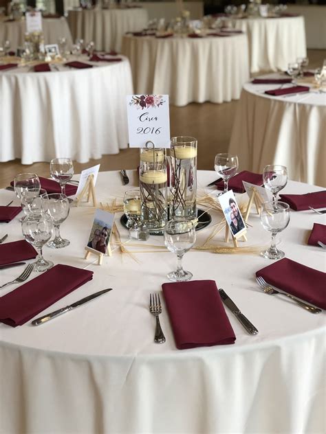 Ivory table linens with burgundy napkins | Burgundy wedding centerpieces, Gold and burgundy ...