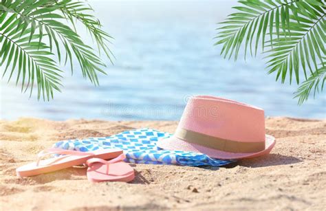Bright Towel Hat And Flip Flops On Sand Near Sea Stock Image Image