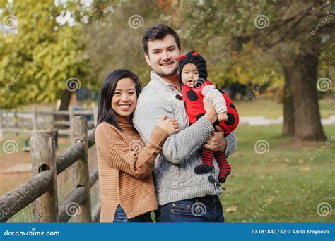 Happy Smiling Asian Chinese Mother And Caucasian Father Dad With Baby