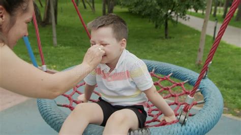 4k mom rides her son on a swing in the park in the summer stock video video of carefree