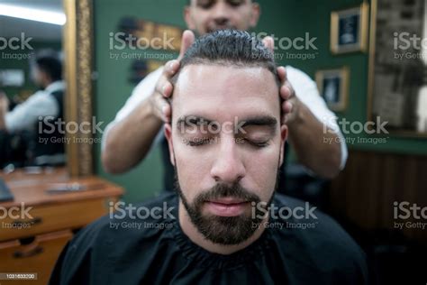 Latin American Customer Getting A Massage On His Hair At The Barber