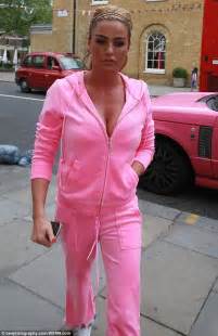 katie price tries to detract attention away from her very swollen lips in garish pink tracksuit