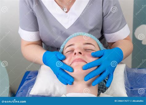 A Female Cosmetologist Manually Treats The Patient`s Skin With A