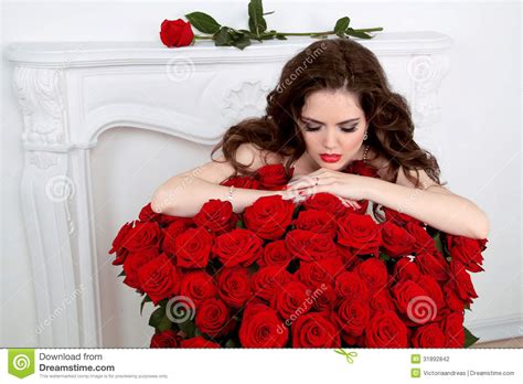 Beautiful Woman Leaning On The Red Roses Bouquet In