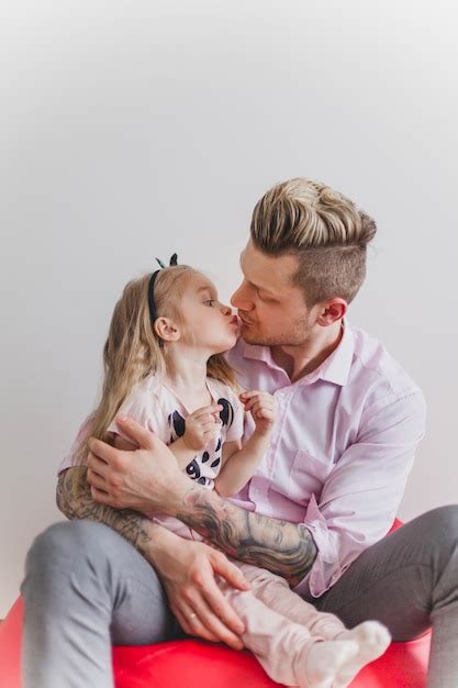 Free Photo Young Father Kissing His Daughter
