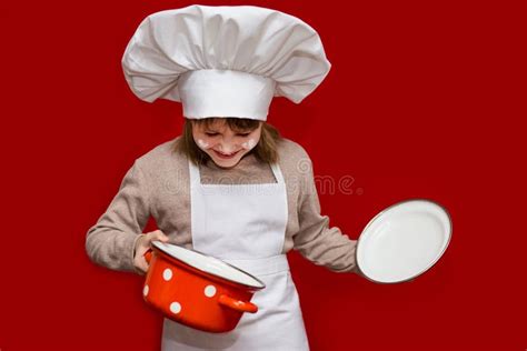 Happy Little Girl In Chef Uniform Holds Saucepan Isolated On Red Kid