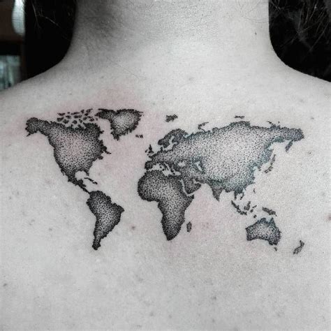 A World Map Tattoo On The Back Of A Mans Chest Is Shown In Black And White