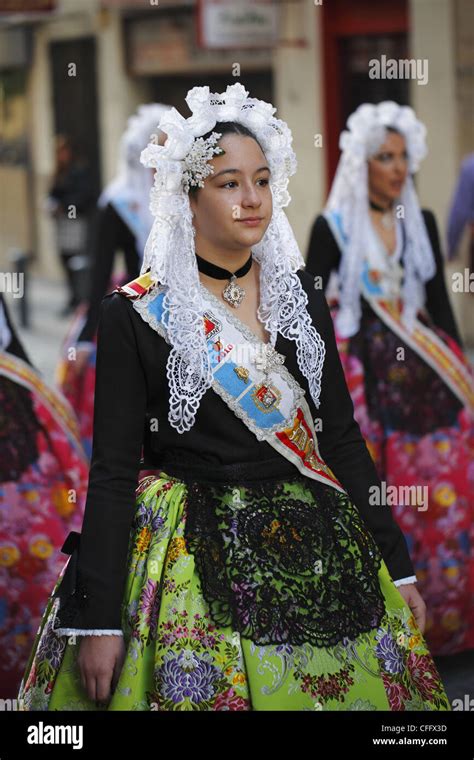 Spanish Girls Wearing Traditional Clothing During The Street Procession