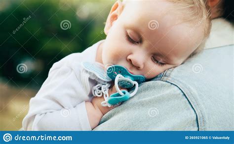 Baby Sleeps On His Mother S Shoulder In The Park Close Up Of A