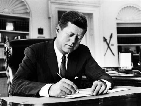 President John F Kennedy Working At His Desk In The Oval Office Of