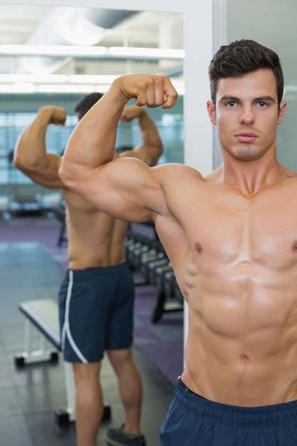 Premium Photo Shirtless Muscular Man Flexing Muscles In Gym