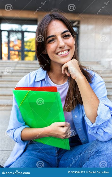 Vertical Portrait Of Young Beautiful Female College Student Sitting