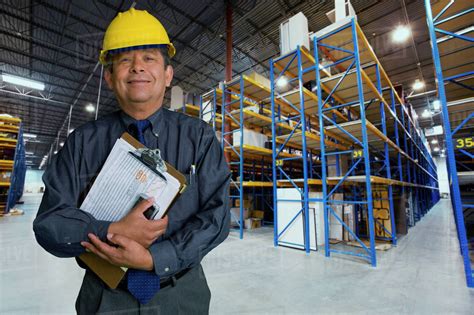 Hispanic Man Working In Warehouse Stock Photo Dissolve