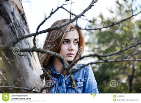 The Girl With Brooding Look Shot Through Branches Stock Photo Image