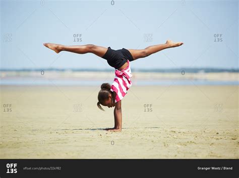 Girl Doing Handstand On Beach Stock Photo Offset