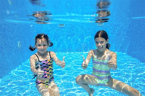 Happy Active Kids Swim In Pool And Play Underwater Stock Photo Image