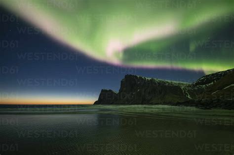 Spectacular Northern Lights Aurora Borealis Fill Sky Over Kvalvika