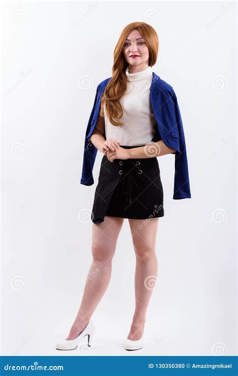 Full Body Shot Of Businesswoman With Jacket Over Shoulder Stock Photo