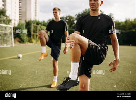 Male Soccer Players Doing Stretching Exercise Stock Photo Alamy