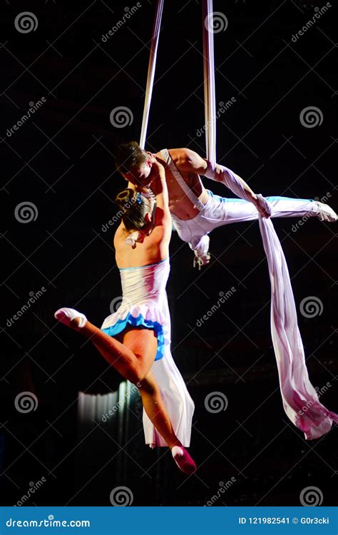 Ale And Female Acrobats Perform Stilt Walking On An Outdoor Stage At Festival In Montreal