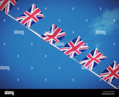 Union Jack Flags Flying In A Clear Blue Sky Stock Photo Alamy