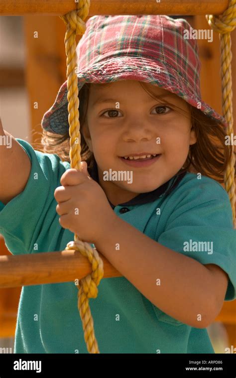 Young Girl Climbing Rope Ladder Stock Photo Alamy