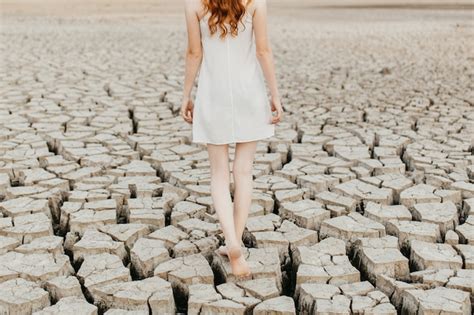 Premium Photo Barefoot Woman Walking On Dry Lake Ground