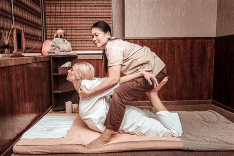 Masseuse Helping Her Client Straightening Her Back Stock Image Image