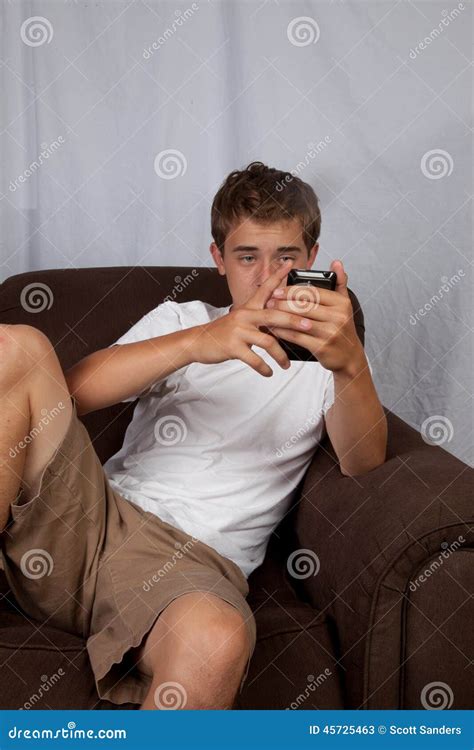Teenage Boy Sitting On Couch Stock Image Image Of Phone Lounging