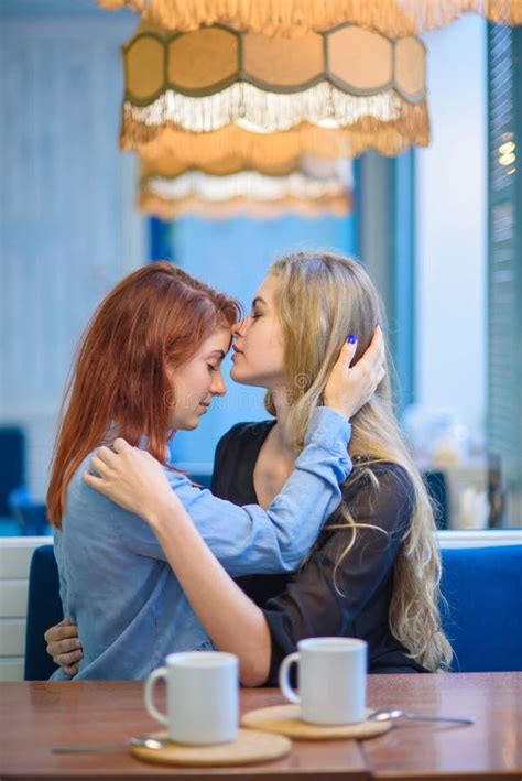 Same Sex Relationships Happy Lesbian Couple Sitting In A Cafe Girls Gently Hold Hands And