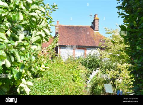 Old English House And Garden In Glynde Village On A Nice Day Stock