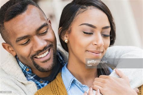 Affectionate Young Mixed Race Couple On Front Porch High Res Stock