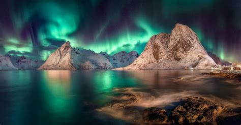 The Swirling Aurora In The Sky Together With The Swirling Water Reine