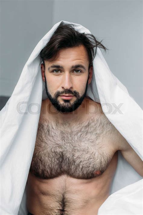 Handsome Shirtless Man Hiding Under Blanket And Looking At Camera Stock Image Colourbox
