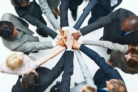 Determined Business Team Joining Hands Together Stock Photo Download